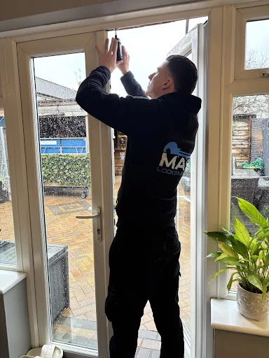Mason from MAS Locksmiths carrying out window lock repairs