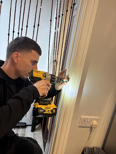 Mason from MAS Locksmiths fitting a lock